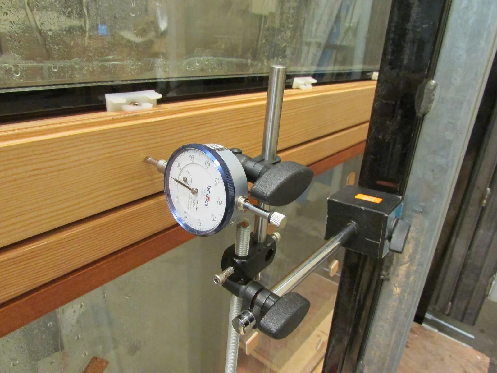 Close view of a deflection gauge measuring a Fenstür timber window