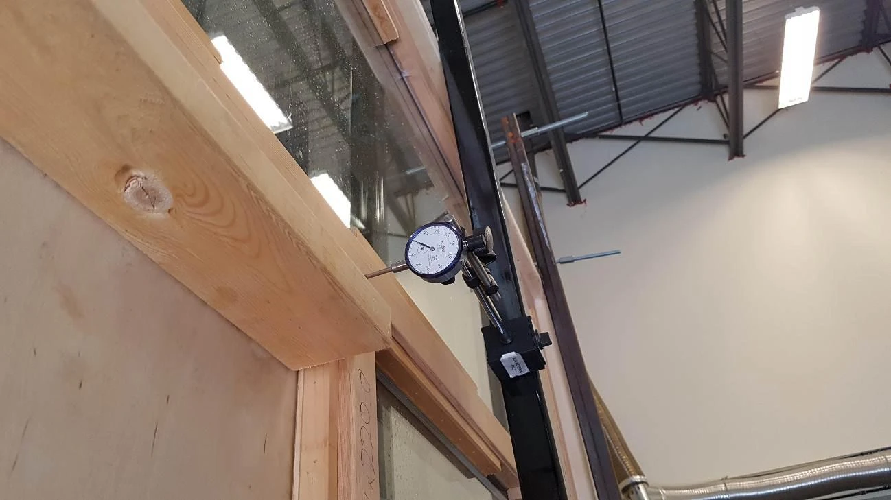 Deflection gauge measuring a timber window during structural testing