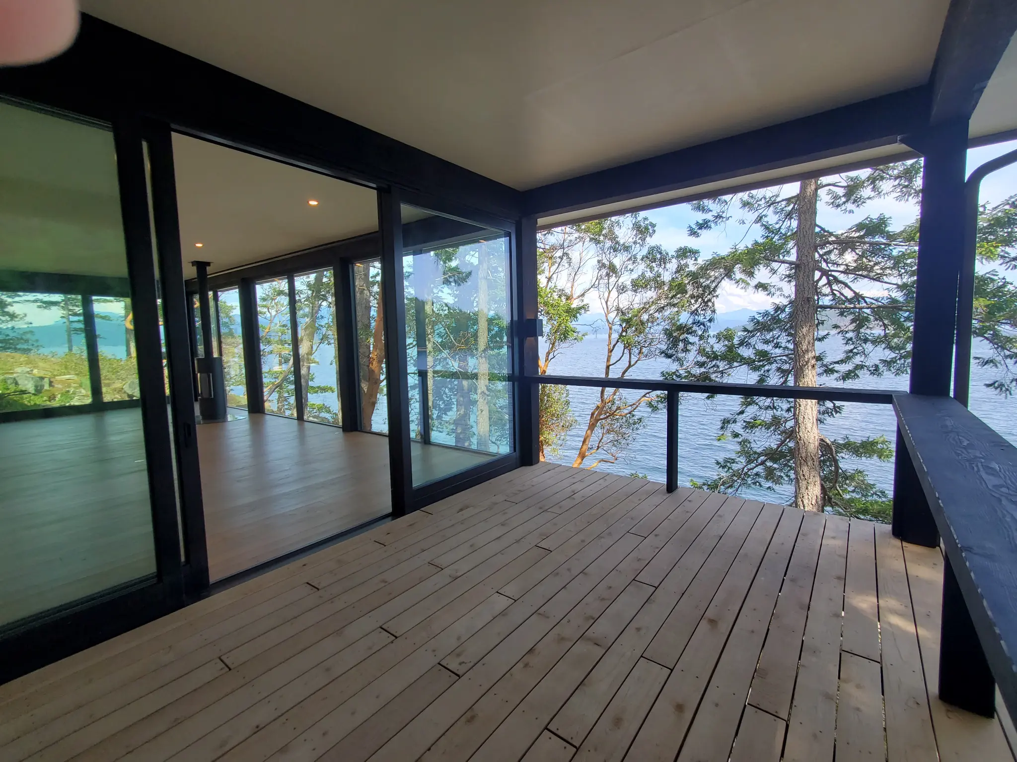 Full-height Fenstür glazing opening a sheltered deck to the water