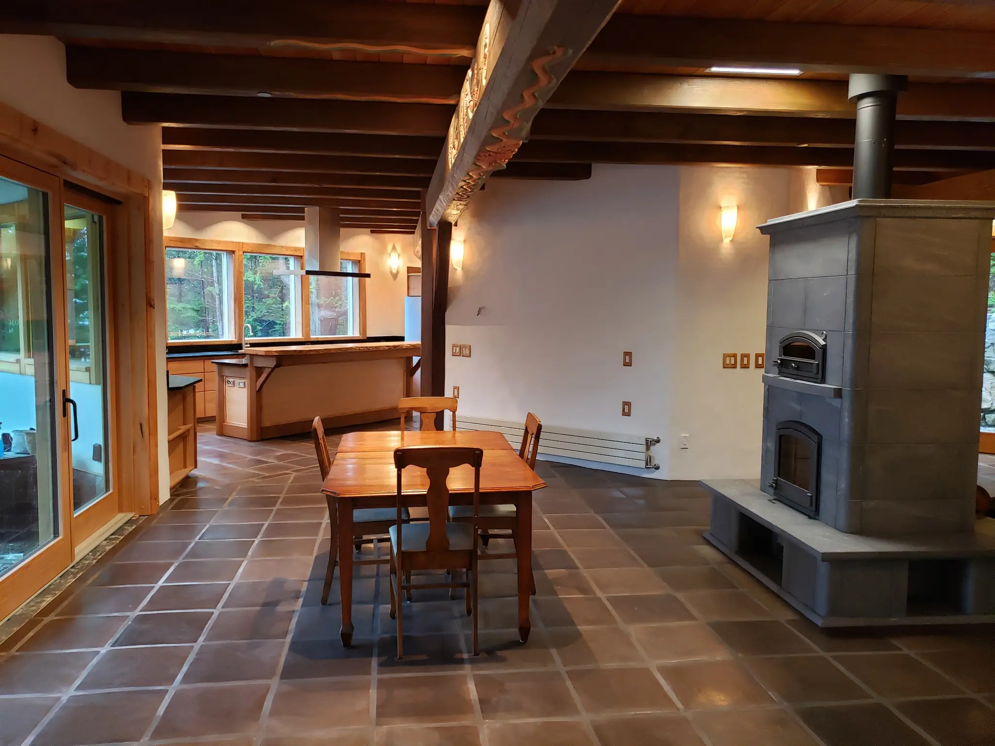 Open living space with wood lift-and-slide door and picture windows