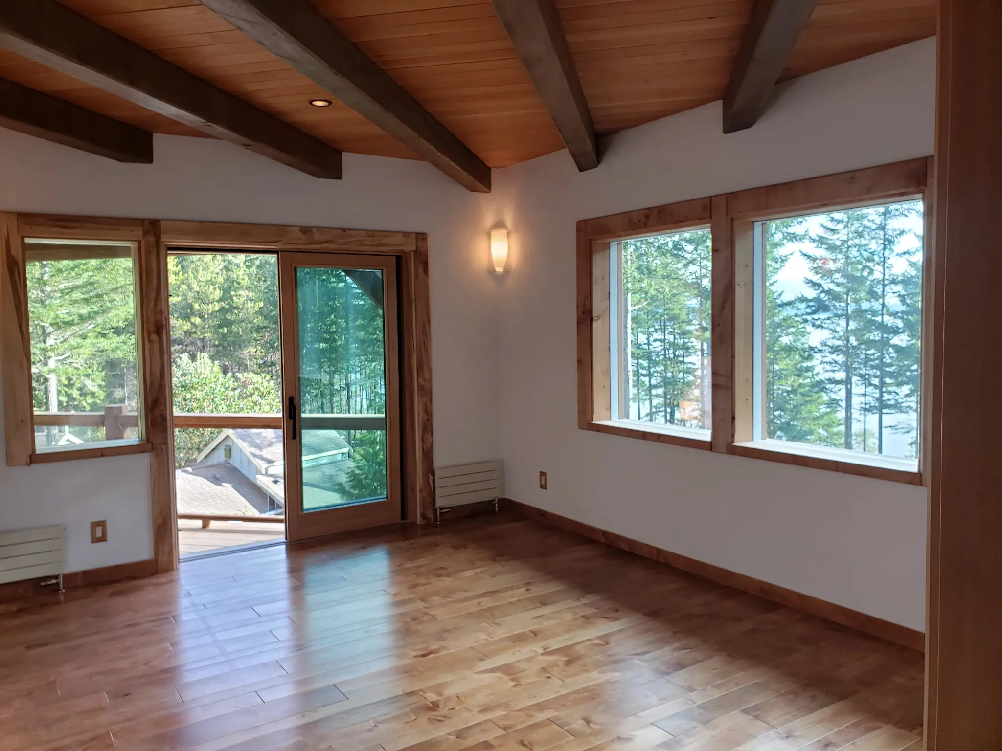 Upper room with wood windows and a glazed exterior door
