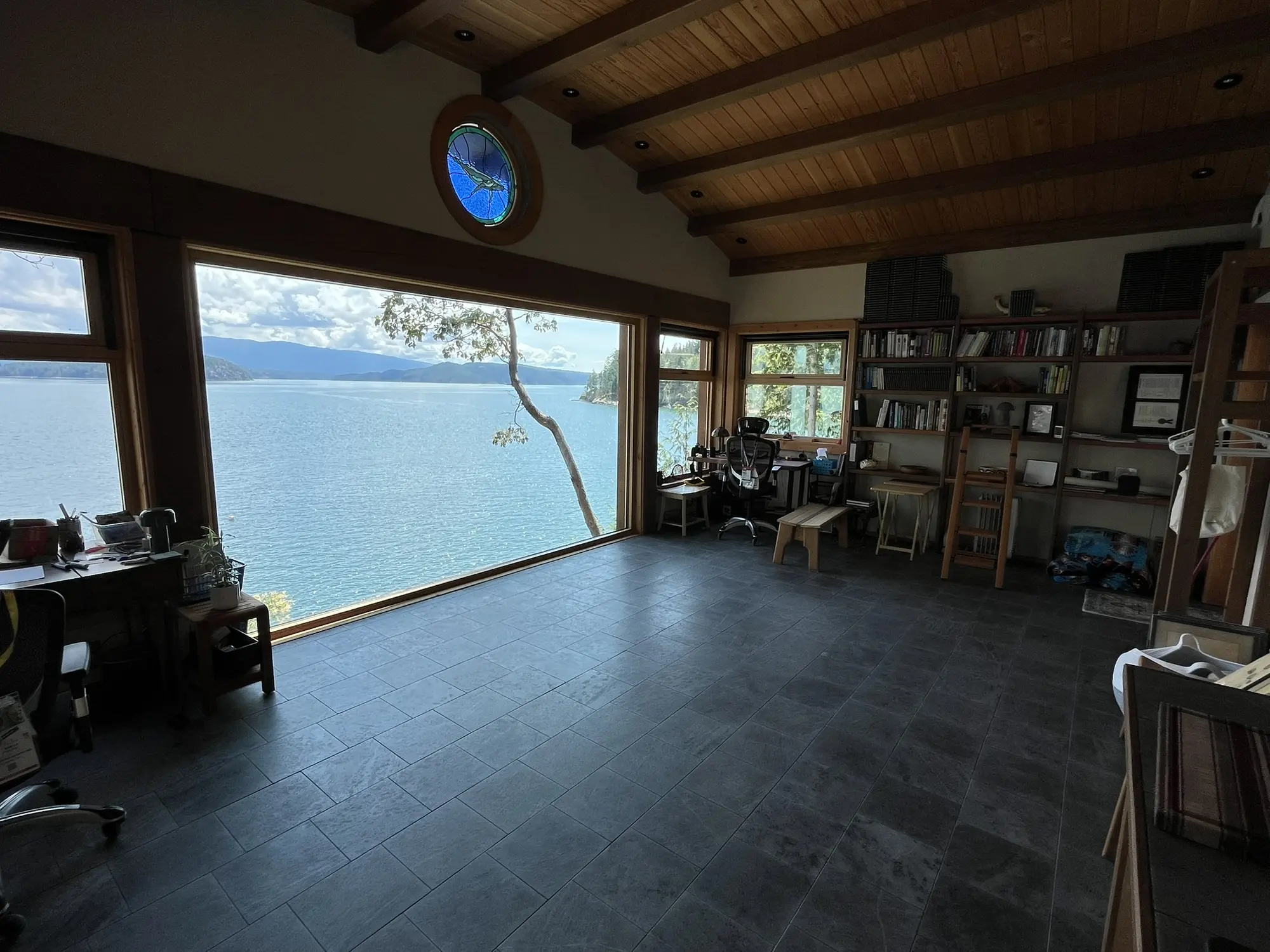 Large all-wood picture window framing the Cortes Island shoreline