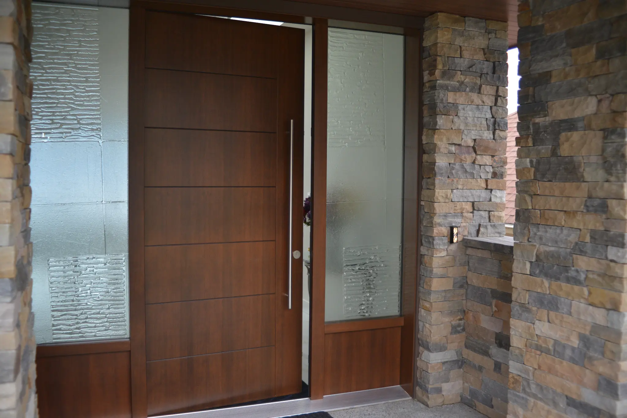 Custom black walnut Fenstür entry door with textured glass sidelites