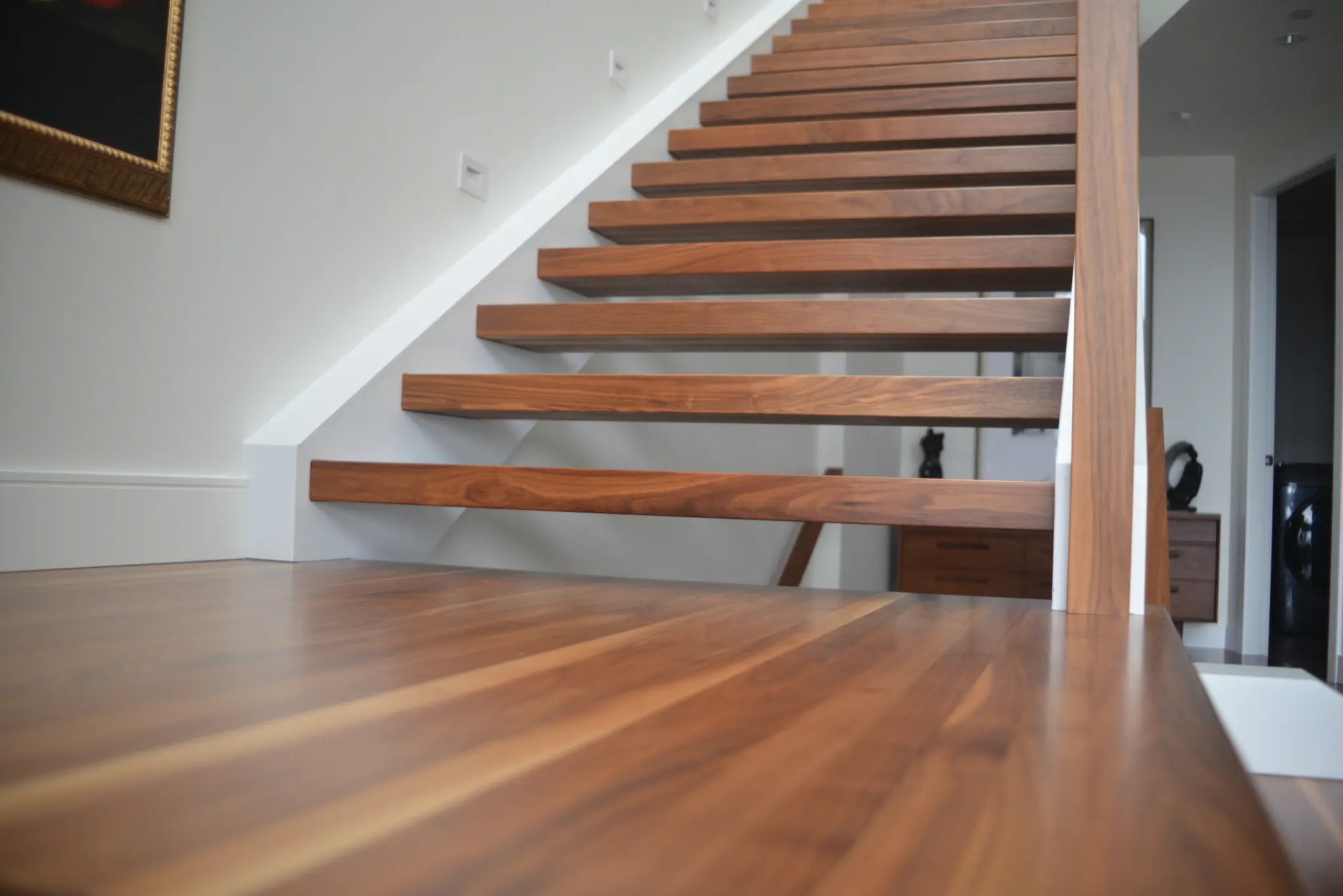 Custom black walnut stair treads, railing and landing