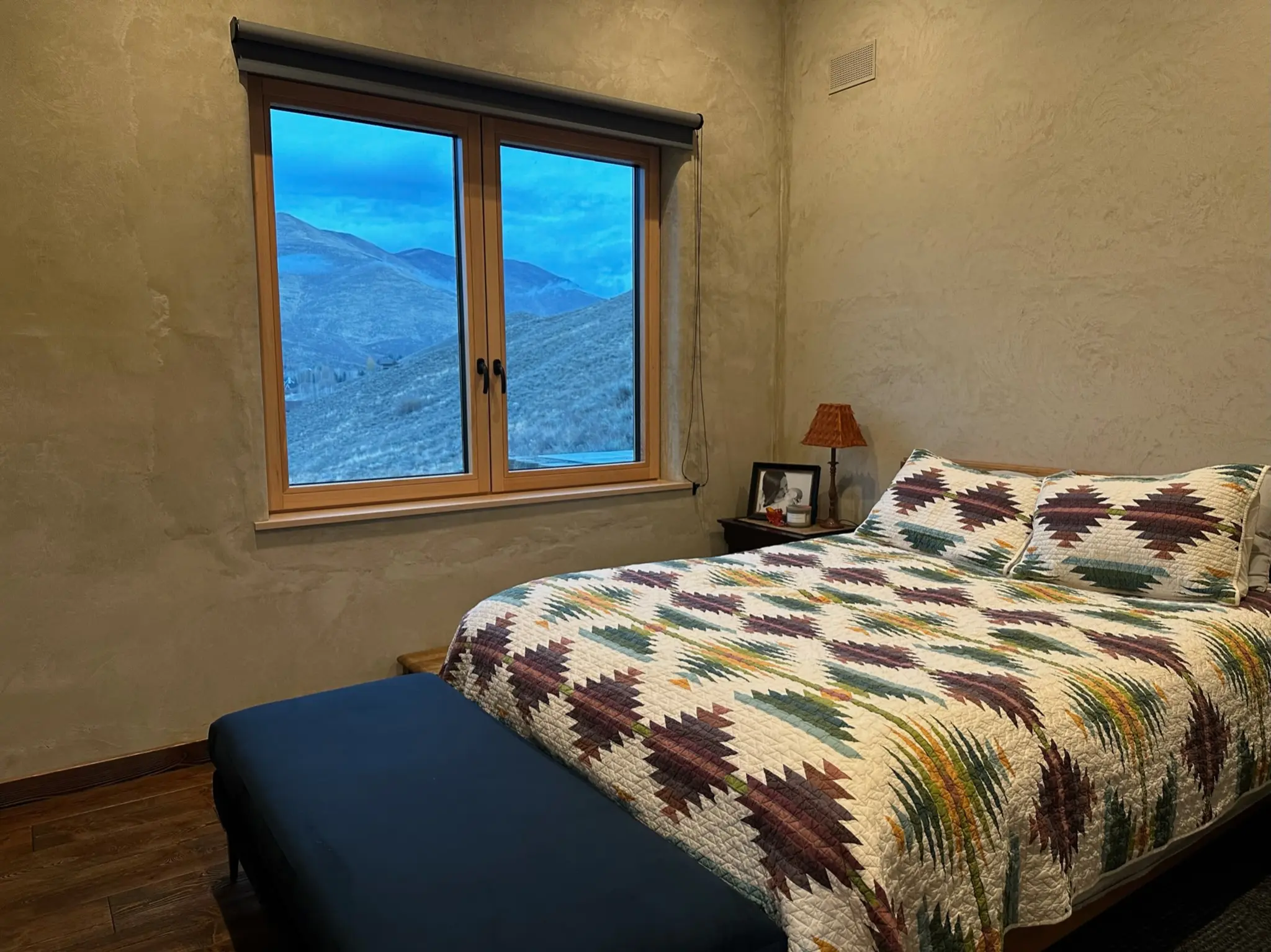 All-wood bedroom window overlooking the mountains