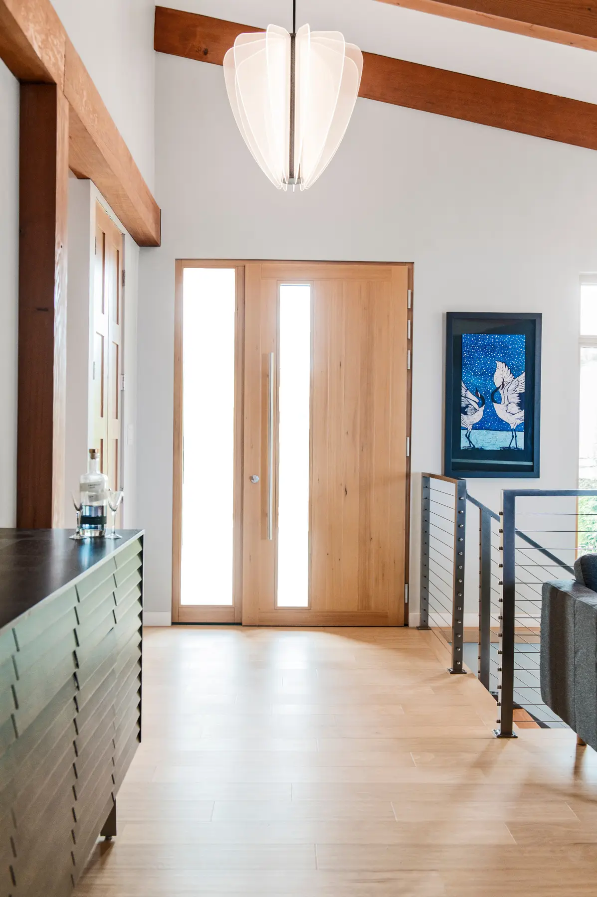 Wood entry door and bright interior hallway