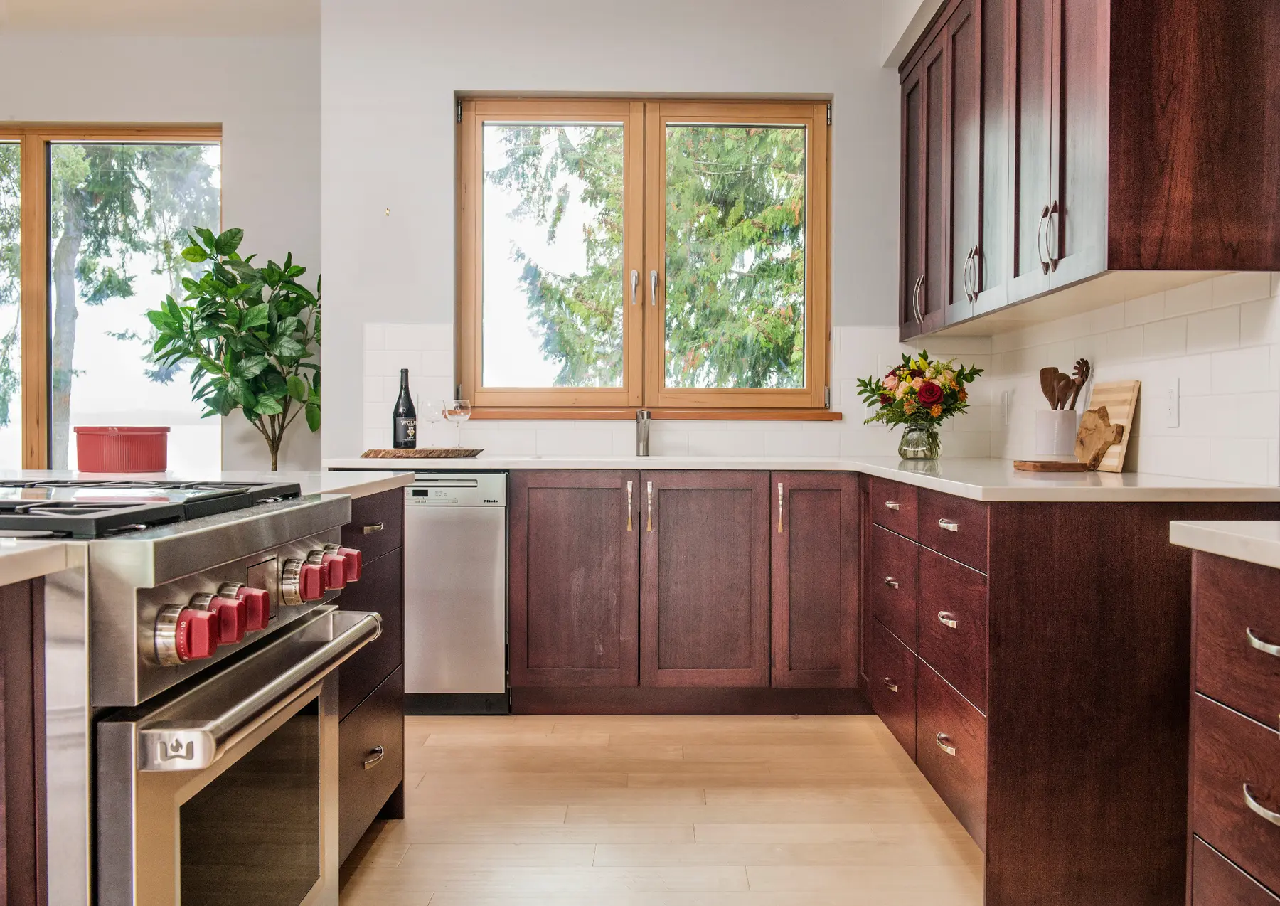 Kitchen picture window framing the forest