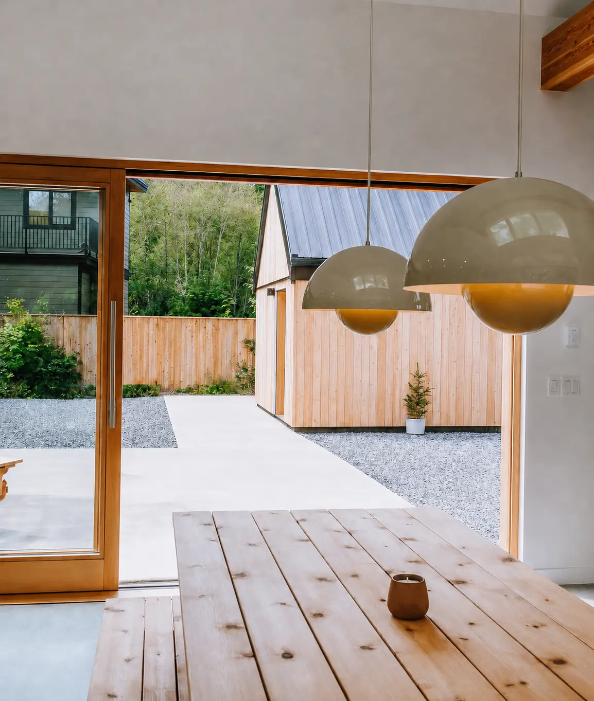 Wood-framed opening connecting the dining room to the sheltered courtyard