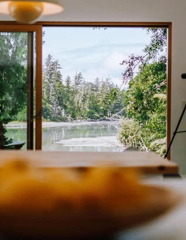 Quiet forest and inlet view framed by the all-wood opening