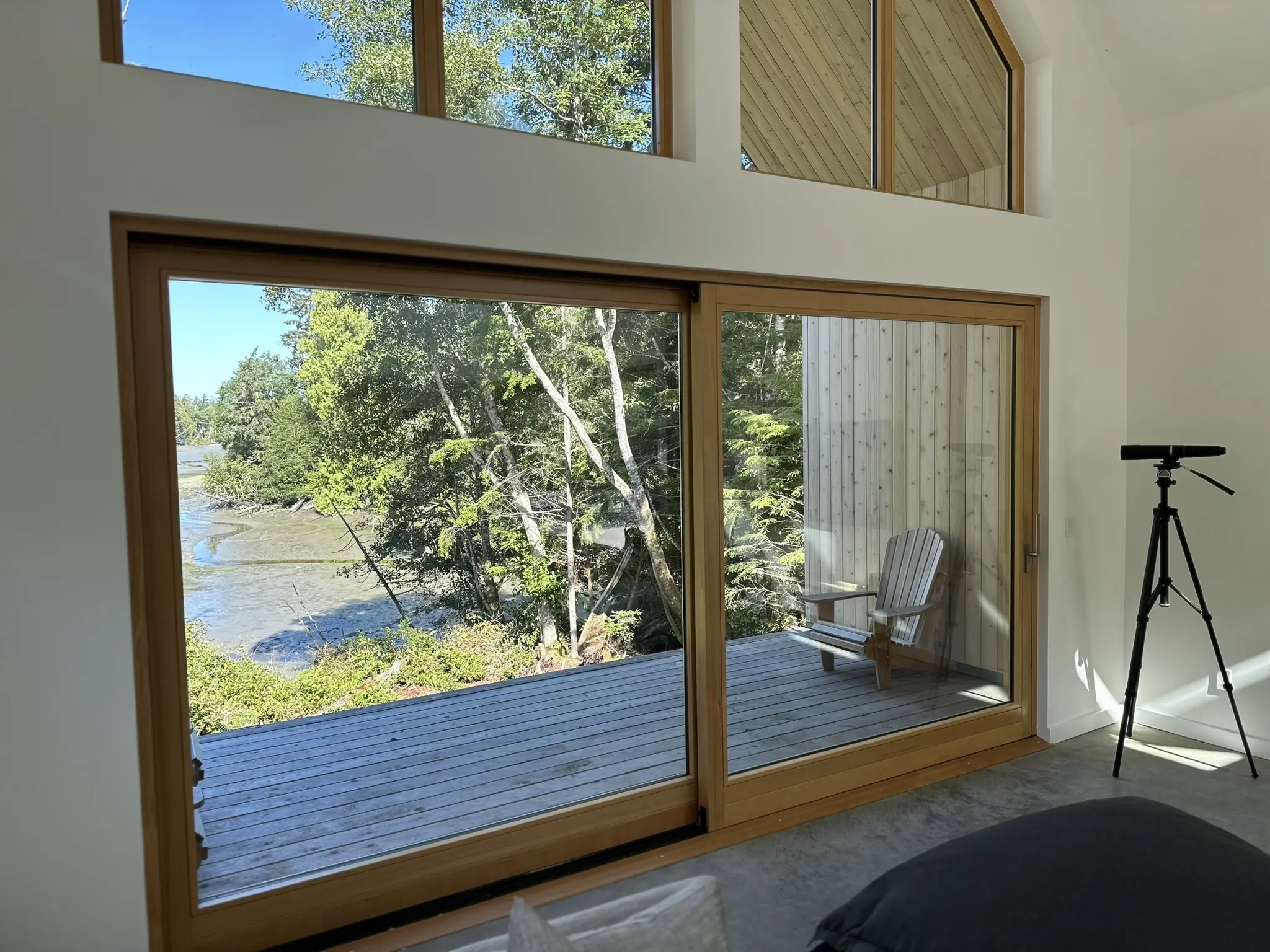 Interior lift-and-slide detail framing the shoreline