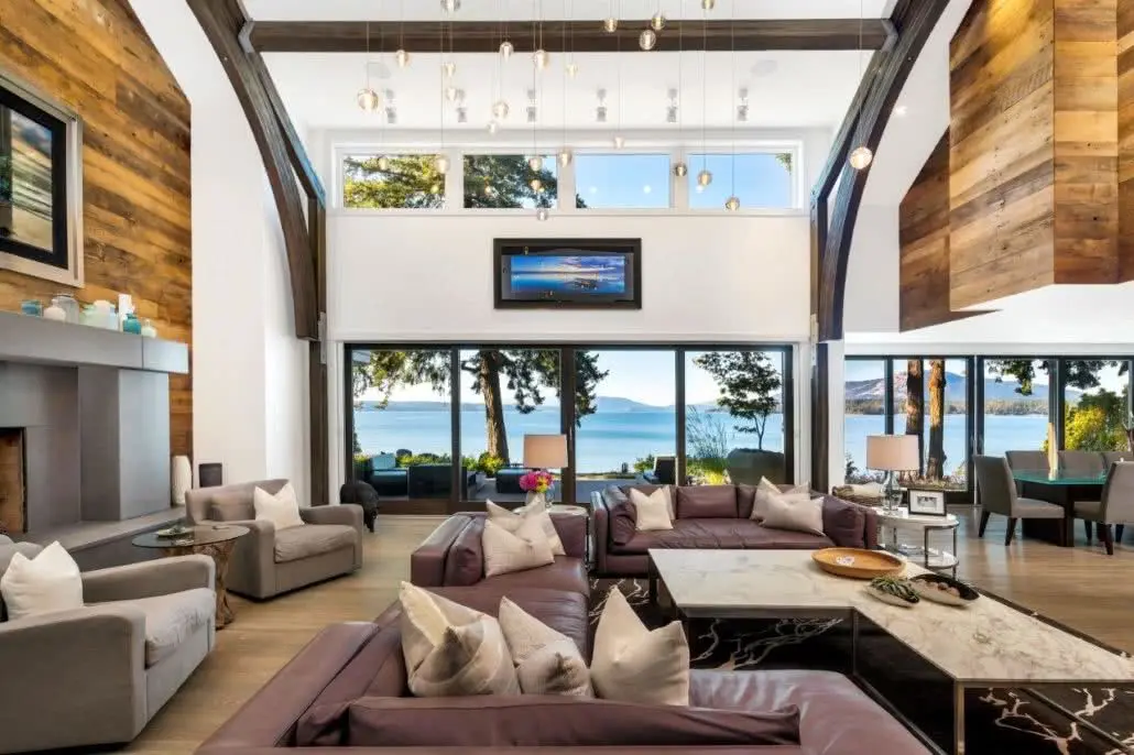 Double-height living room framed by broad glazed openings