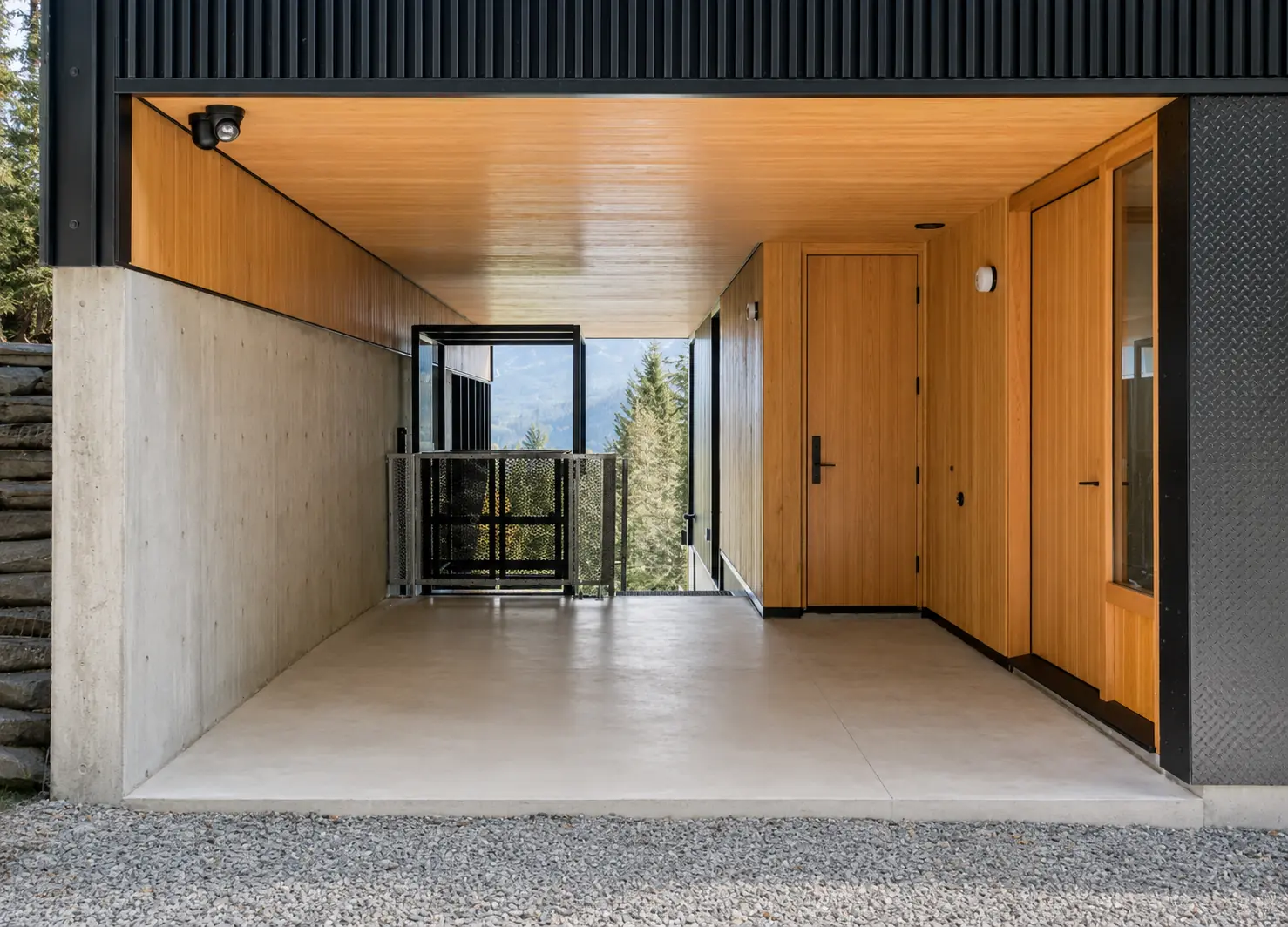 Natural-wood Fenstür entry door and matching window within a sheltered Whistler entrance