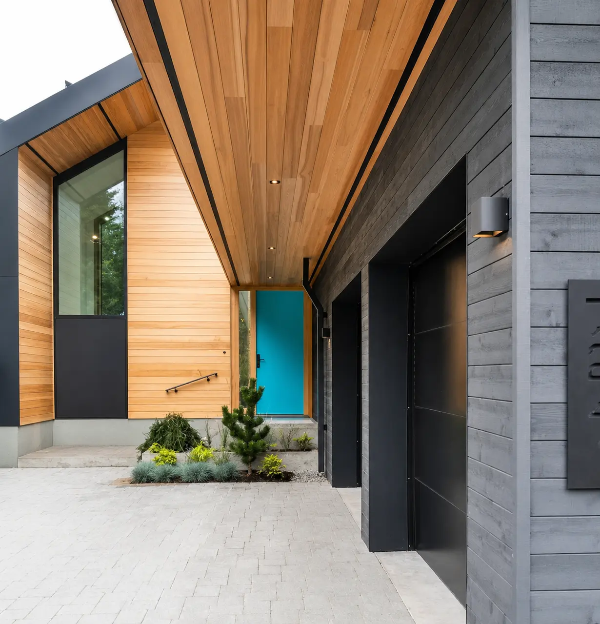 Turquoise custom Fenstür entry door at a contemporary Whistler home