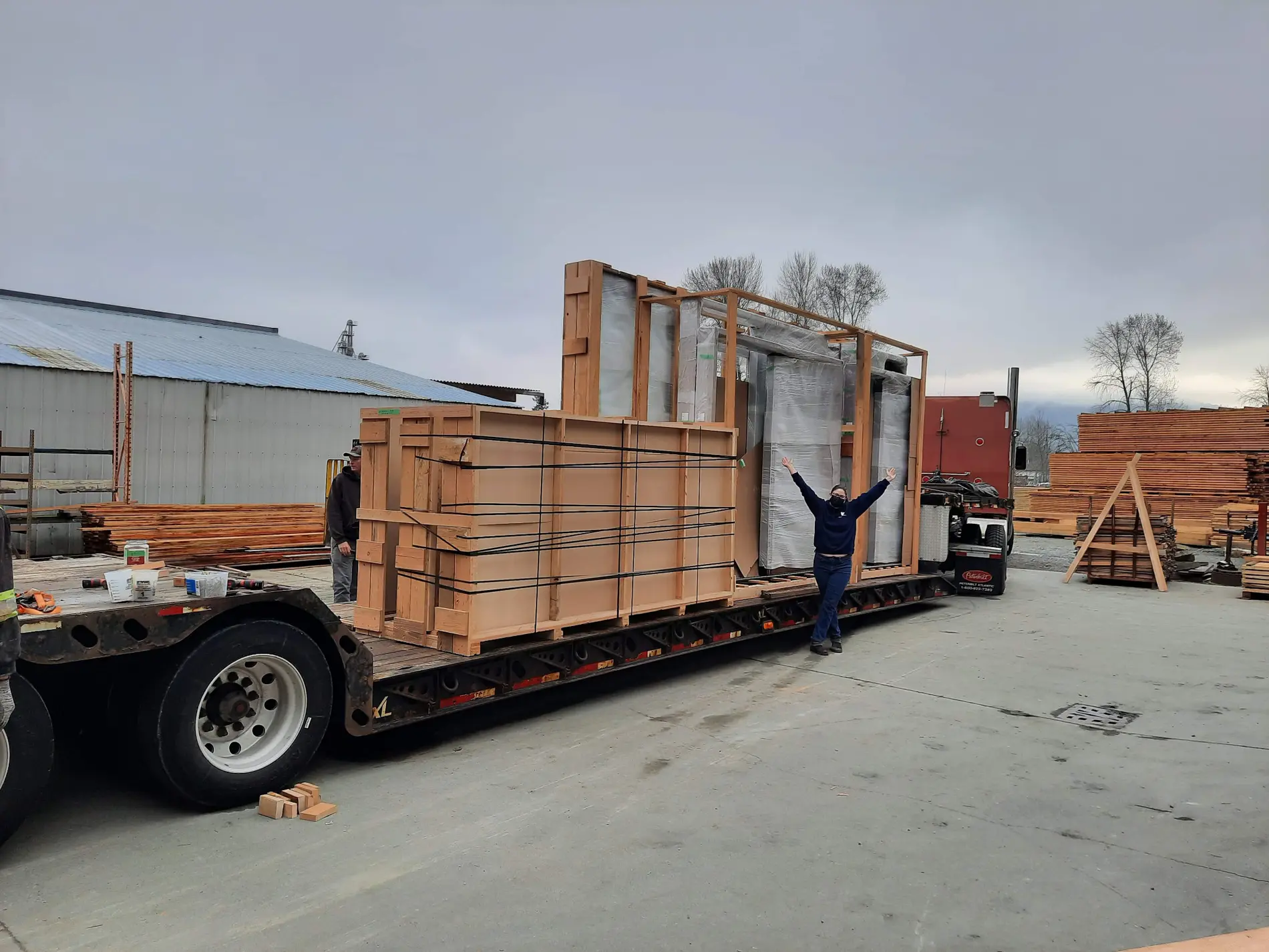 Large protected Fenstür window and door packages secured on a commercial flatbed trailer